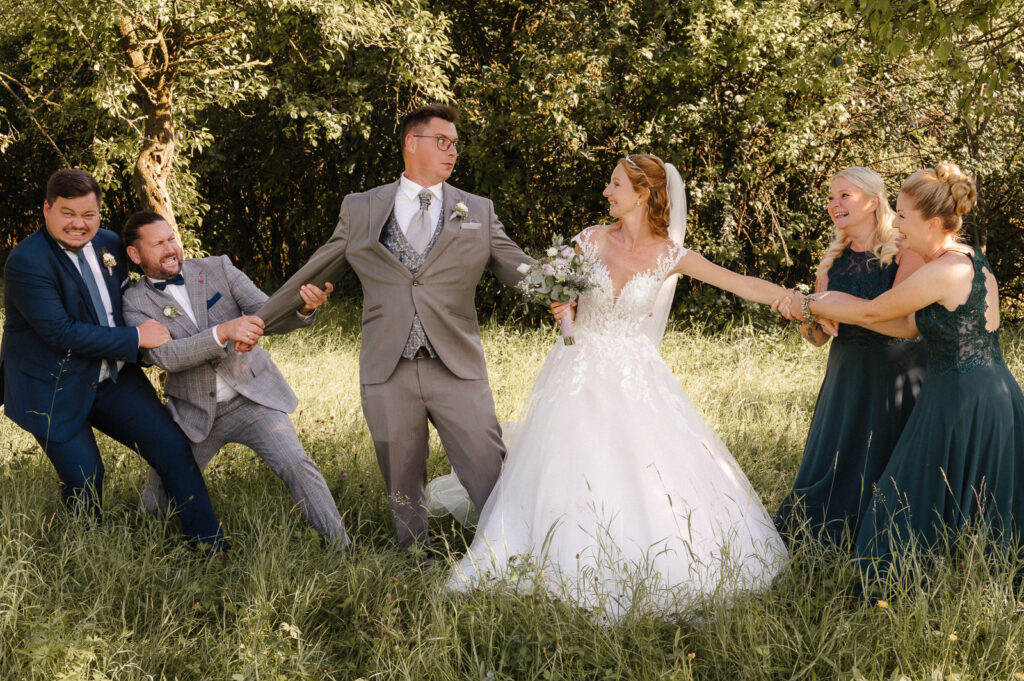 Lustiges Gruppenbild auf der Wiese, Brautpaar und Trauzeugen